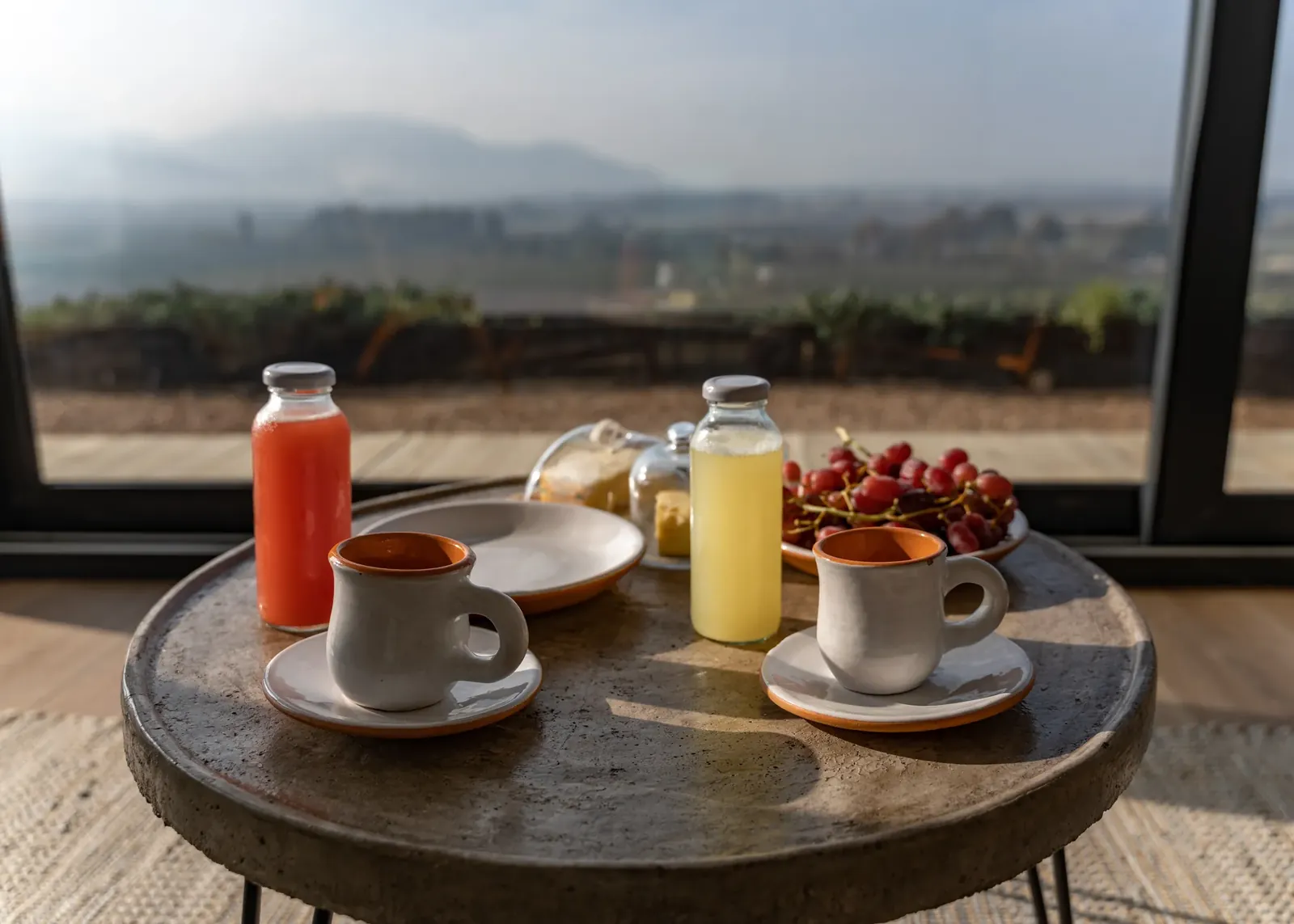 Desayuno servido en la terraza, con el valle de fondo.